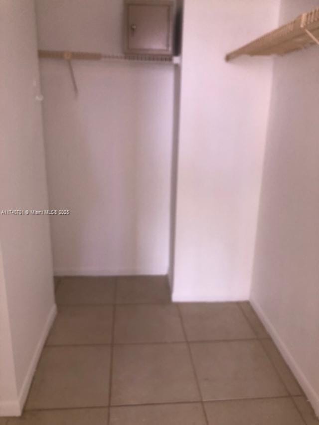 walk in closet featuring tile patterned flooring