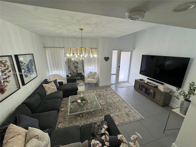 tiled living room with a notable chandelier