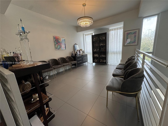 tiled living room featuring a chandelier