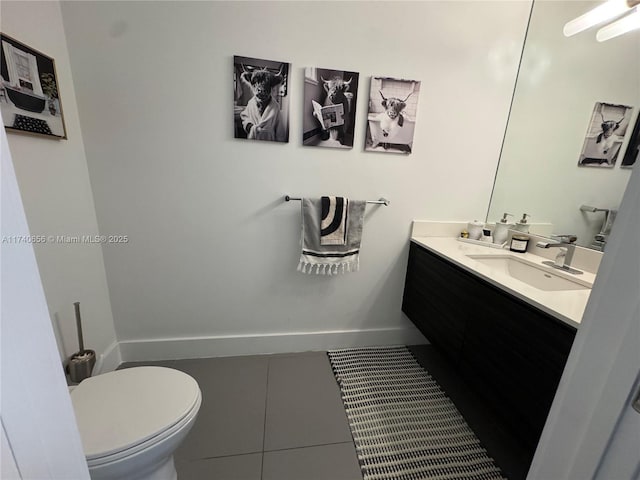 bathroom featuring tile patterned flooring, vanity, and toilet