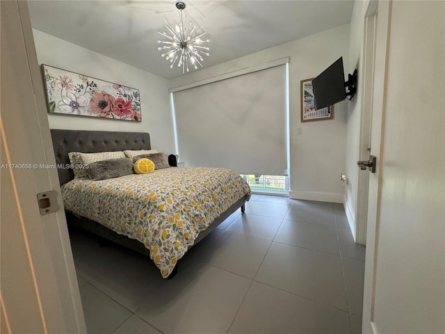 tiled bedroom featuring an inviting chandelier