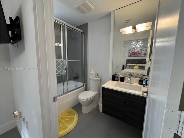 full bathroom with vanity, combined bath / shower with glass door, tile patterned floors, and toilet