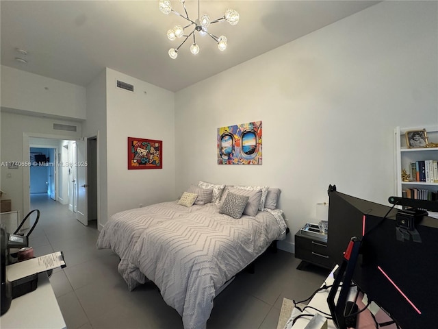 bedroom featuring an inviting chandelier and light tile patterned floors