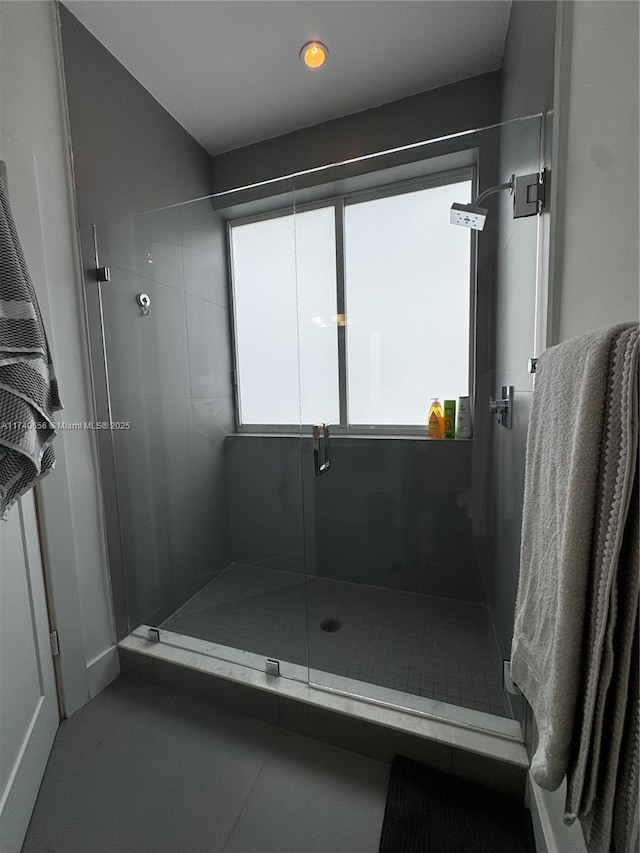 bathroom featuring tile patterned flooring and a shower with door