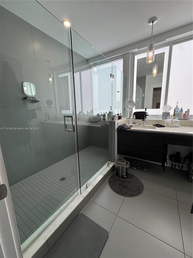 bathroom with vanity, a shower with shower door, and tile patterned flooring