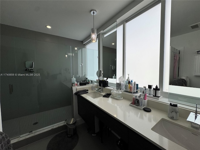 bathroom featuring vanity and tiled shower