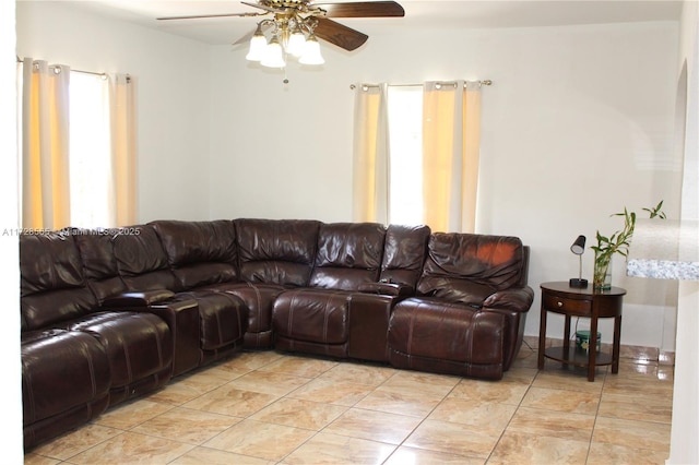 living room featuring light tile patterned floors and ceiling fan