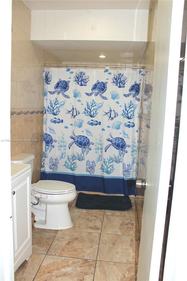 bathroom featuring tile patterned flooring, vanity, and toilet