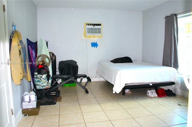 bedroom featuring a wall mounted AC and light tile patterned flooring