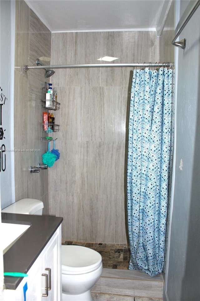 bathroom featuring vanity, curtained shower, tile walls, and toilet