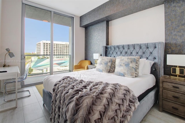 tiled bedroom featuring floor to ceiling windows