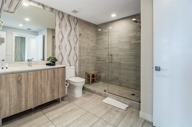 bathroom with vanity, toilet, and walk in shower