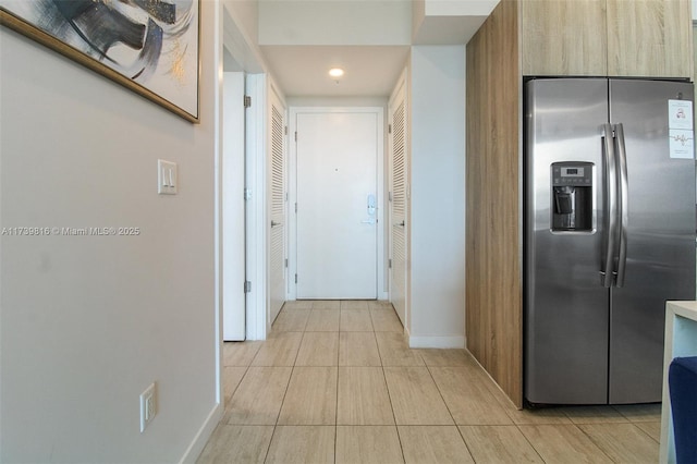 hall featuring light tile patterned floors