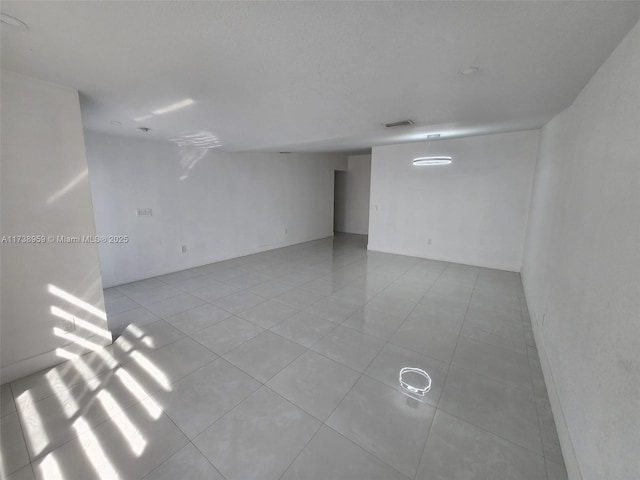 unfurnished room with light tile patterned floors