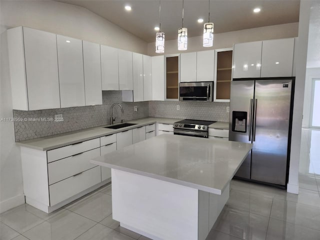 kitchen with white cabinetry, sink, hanging light fixtures, a center island, and stainless steel appliances