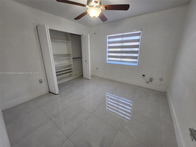 unfurnished bedroom featuring light tile patterned floors, a closet, and ceiling fan