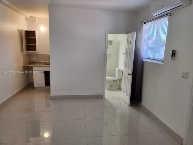 corridor featuring light tile patterned floors and a wall mounted AC