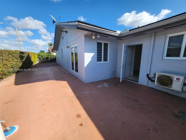 view of property exterior with a patio area and ac unit