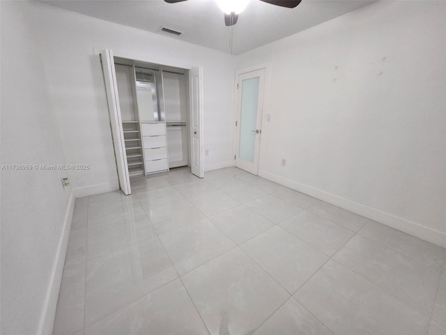 unfurnished bedroom featuring light tile patterned floors, ceiling fan, and a closet