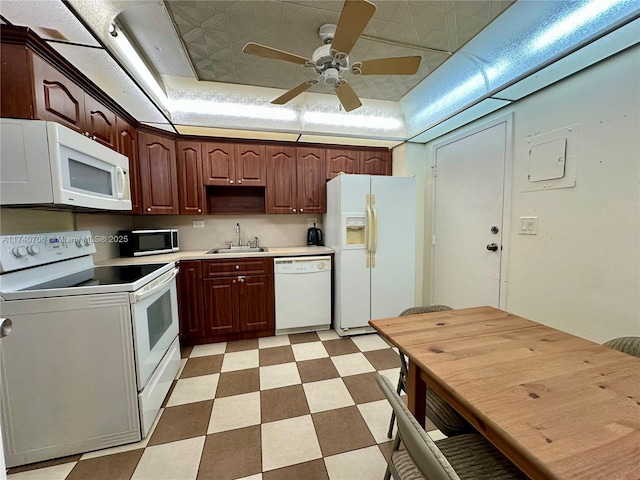 kitchen featuring sink, white appliances, a raised ceiling, and ceiling fan