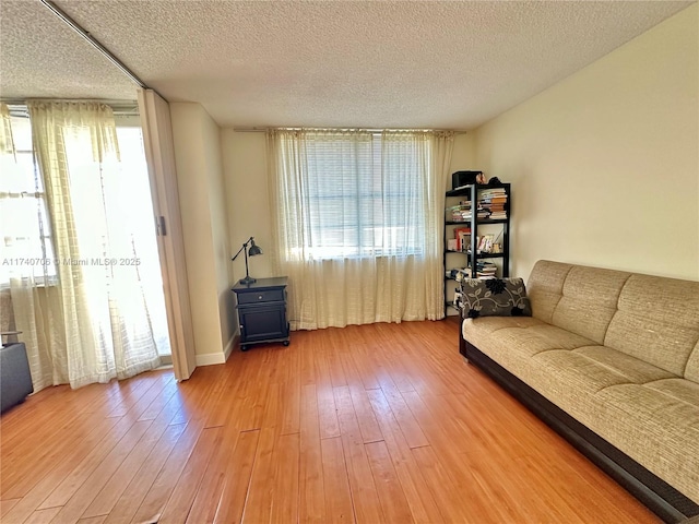 unfurnished living room with hardwood / wood-style floors and a textured ceiling