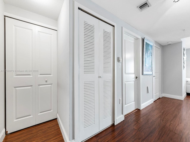 corridor featuring dark hardwood / wood-style floors