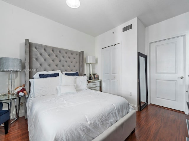 bedroom with dark hardwood / wood-style flooring