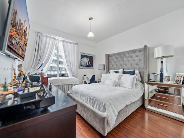 bedroom featuring dark hardwood / wood-style floors and access to outside