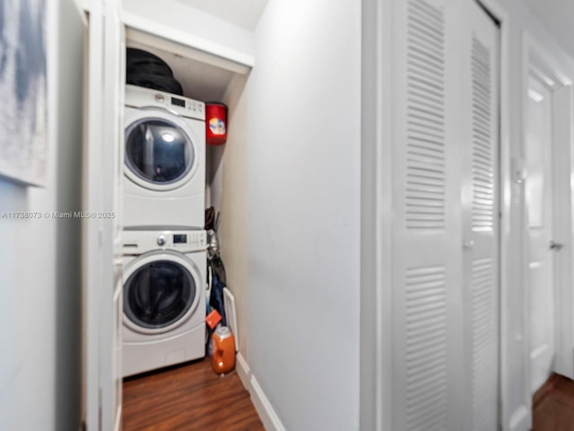 laundry room with stacked washer / dryer and dark hardwood / wood-style floors