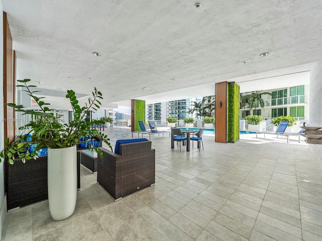 view of patio / terrace with a community pool and outdoor lounge area