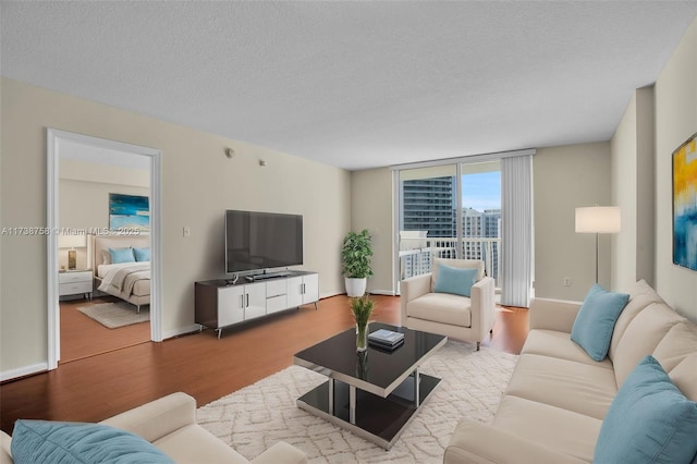 living room with hardwood / wood-style flooring and a textured ceiling