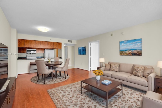 living room with light hardwood / wood-style flooring