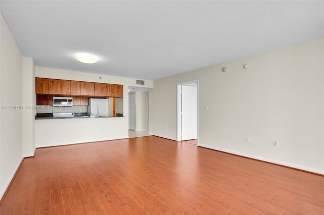 unfurnished living room with light hardwood / wood-style floors