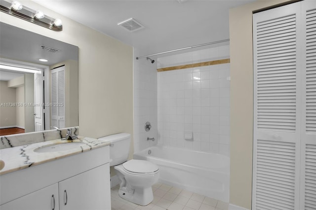 full bathroom with vanity, tiled shower / bath, tile patterned flooring, and toilet