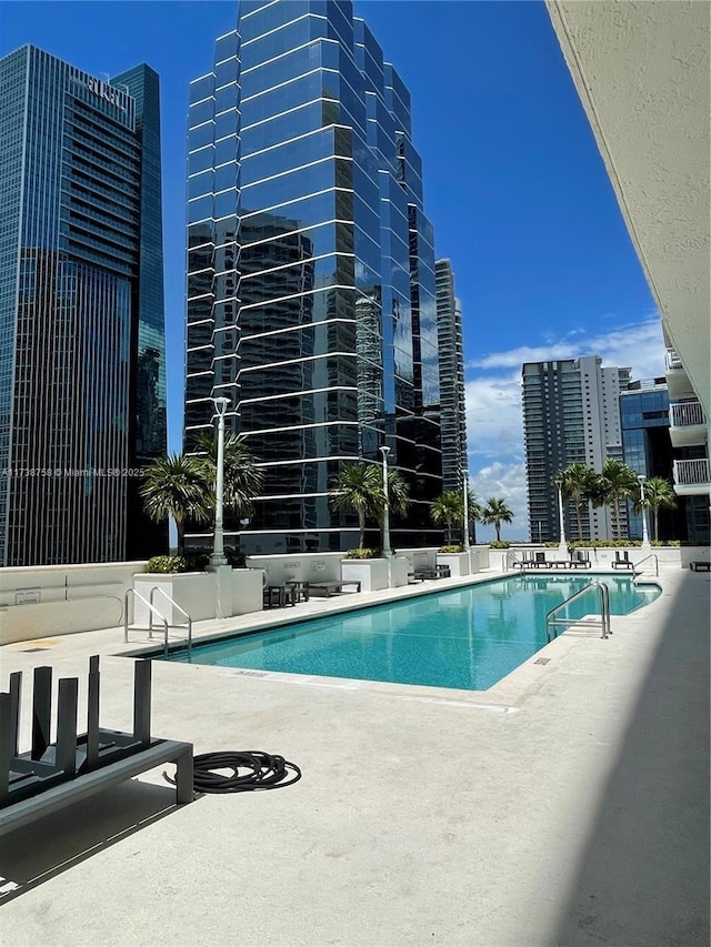 view of swimming pool featuring a patio area