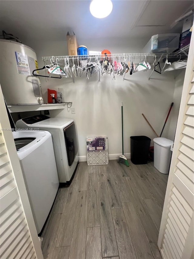 laundry room featuring wood-type flooring and washer and dryer