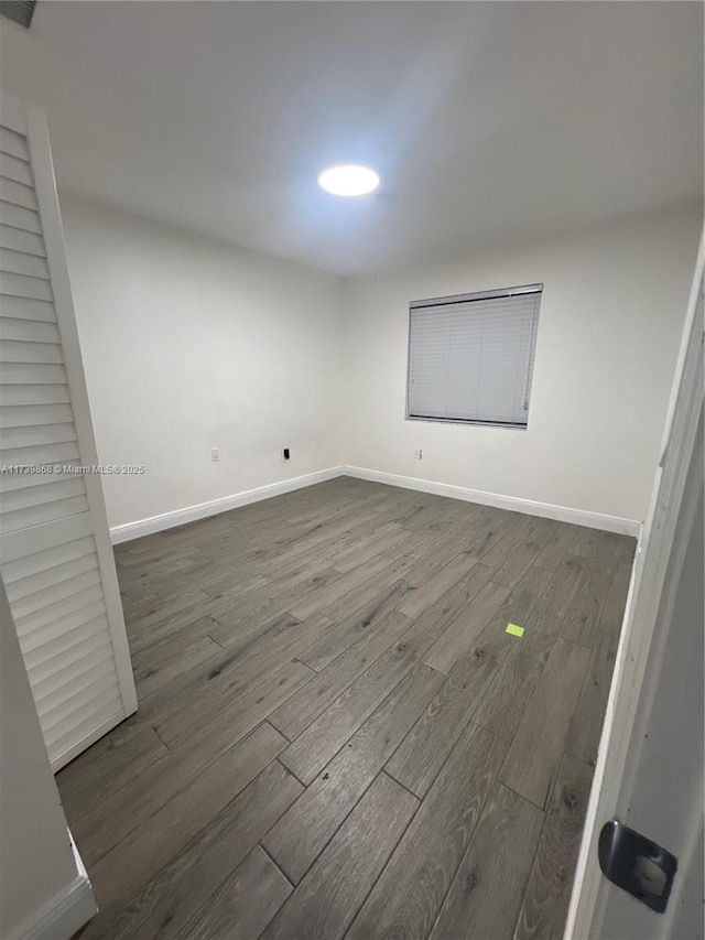 unfurnished bedroom with dark hardwood / wood-style flooring