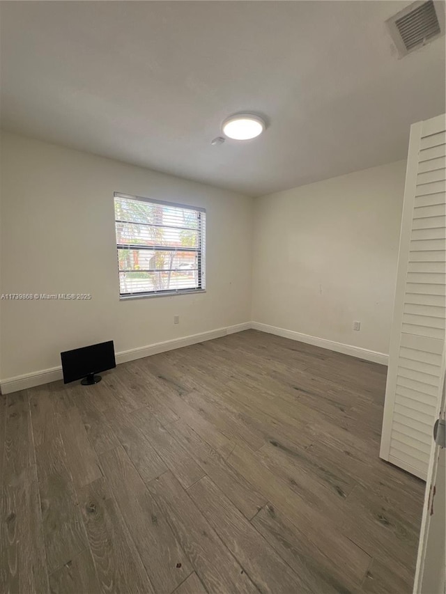 empty room featuring dark wood-type flooring