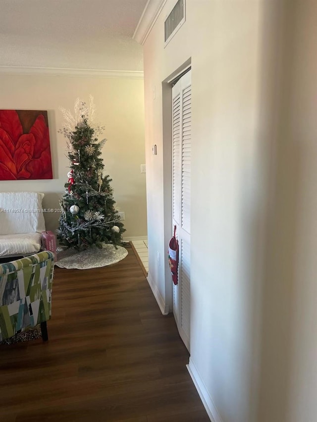 hall with crown molding and hardwood / wood-style floors