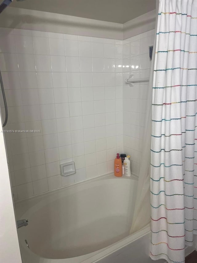 bathroom with shower / bath combination with curtain