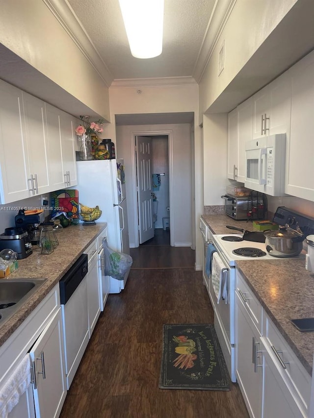 kitchen with crown molding, dark wood-type flooring, white cabinets, and white appliances