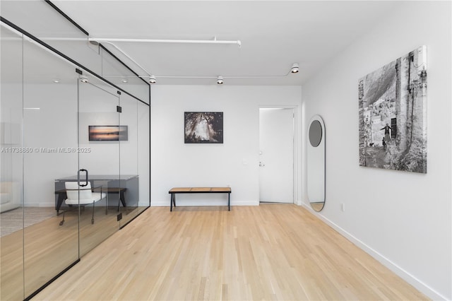 hall with hardwood / wood-style floors