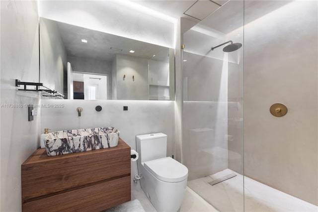 bathroom featuring vanity, toilet, and a shower