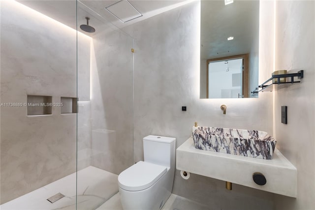 bathroom with tiled shower and toilet