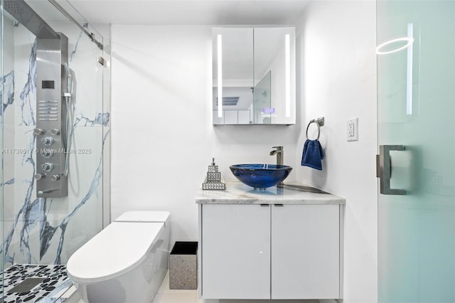 bathroom featuring vanity, walk in shower, and toilet