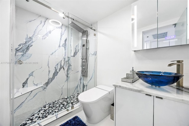 bathroom featuring vanity, toilet, and an enclosed shower