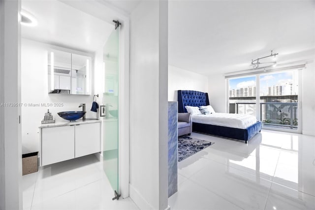 tiled bedroom featuring sink