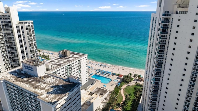 birds eye view of property featuring a water view and a view of the beach