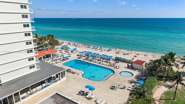 drone / aerial view featuring a view of the beach and a water view