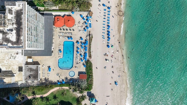 drone / aerial view featuring a water view and a beach view